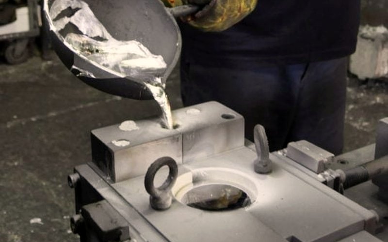 Gravity die casting — ladle-pouring metal into a metal mould